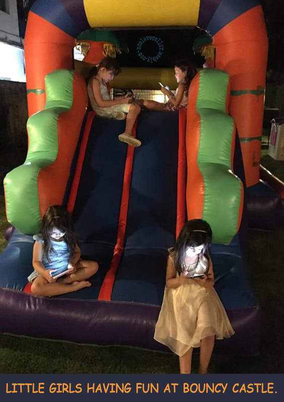 Little girls having fun at bouncy castle