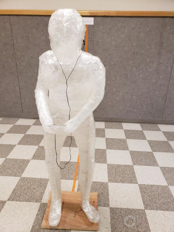 Tape art project on controversial issues in a high school - One of the tape statues before someone lit a project on fire and all of them had to be taken down.