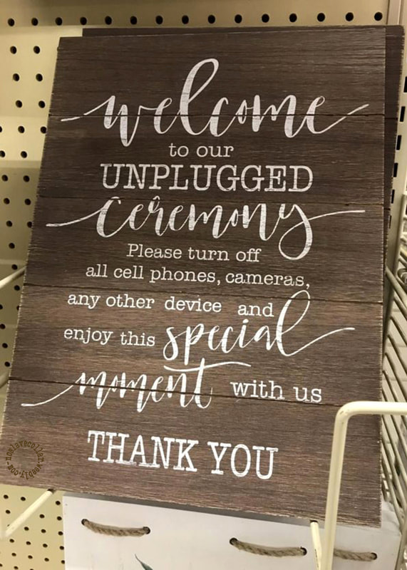 As seen in a shop - 'Welcome to our unplugged ceremony...' sign