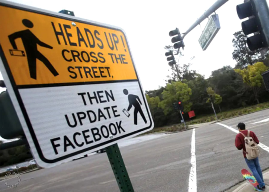 Heads up! Cross the street, then update Facebook - sign