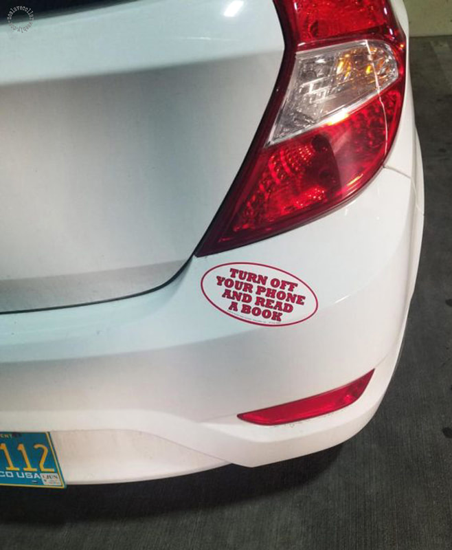 Turn off your phone and read a book - sticker on a car