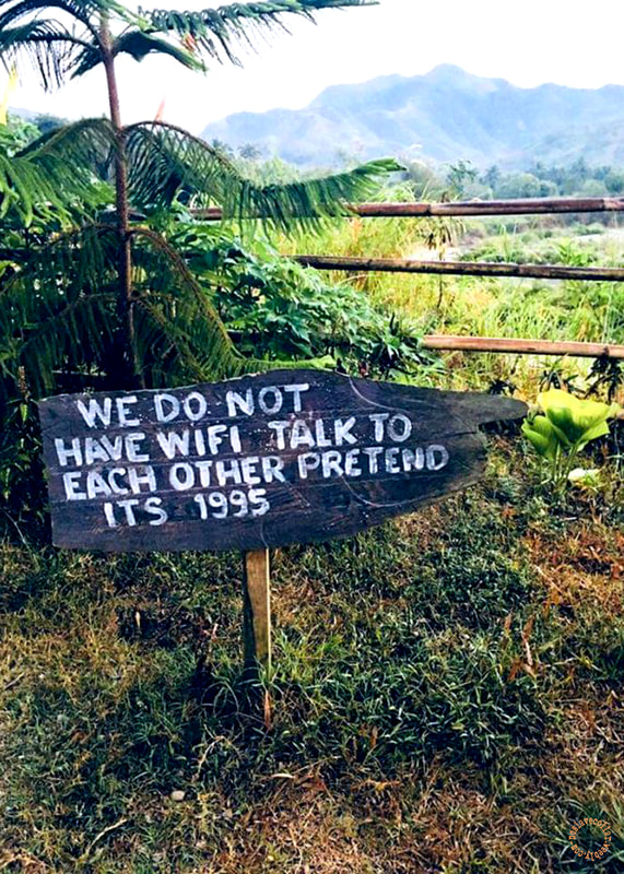 'We do not have Wifi, talk to each other, pretend it's 1995' sign, seen in a beautiful place